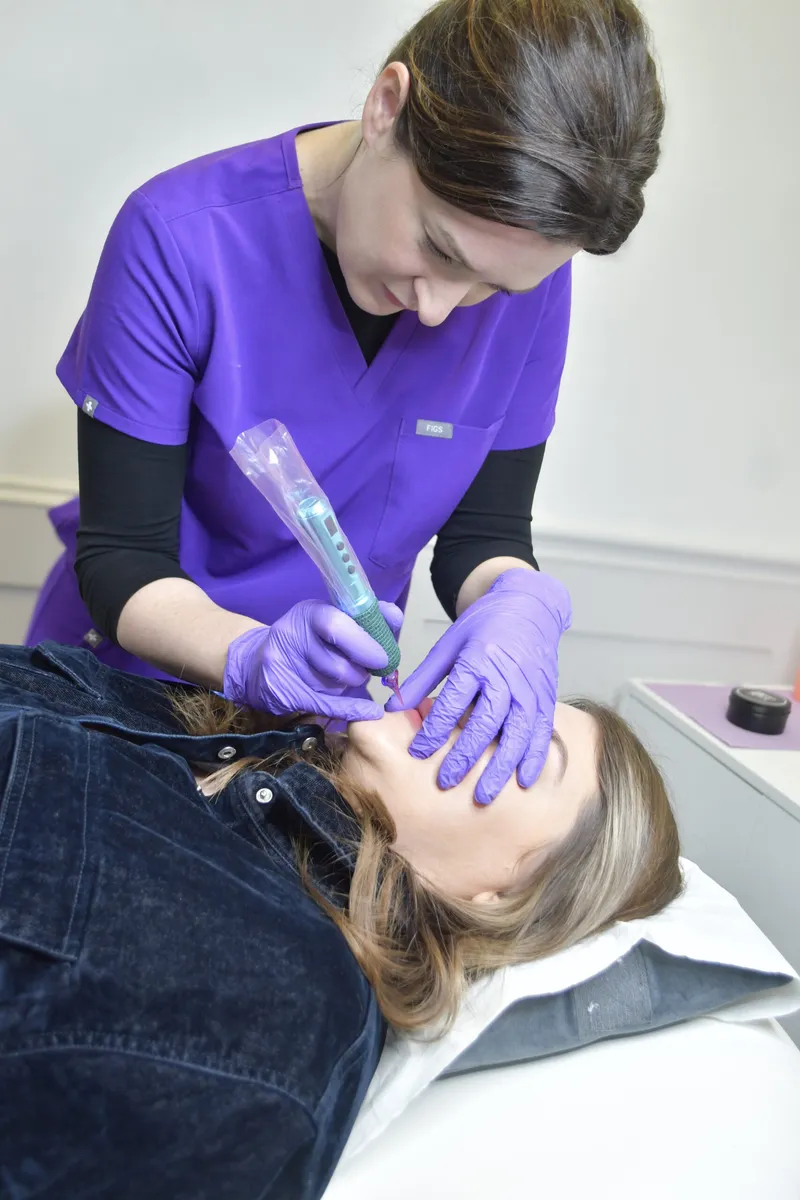 Linda measuring and mapping a client's brow shape during a consultation