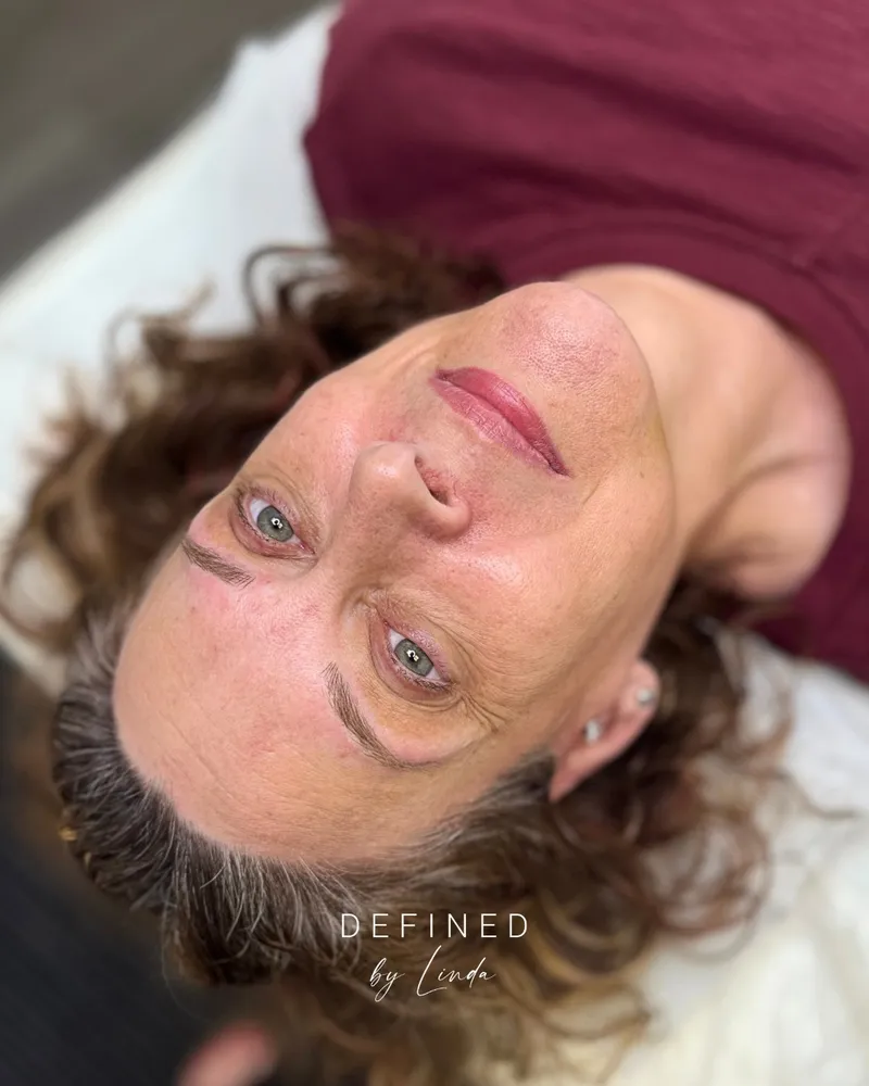 Close-up of a client's lips and eyes showing a soft, natural lip blush result